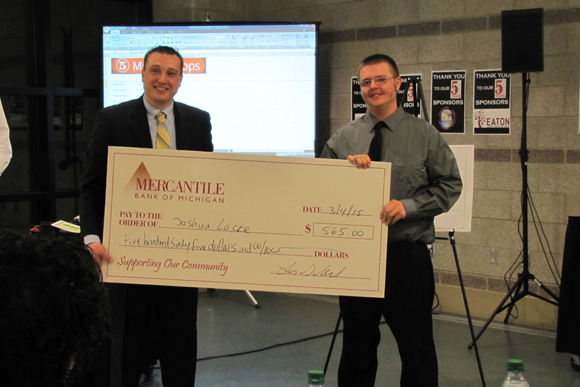 Joshua Locke receiving check from Lucas Schrauben.