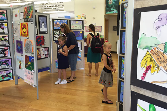 Guests browse the Otsego art exhibit.