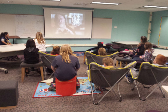 Coding Club Students watching a code.org video.