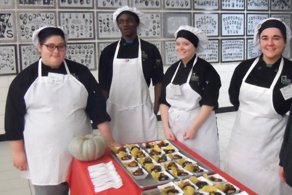 Left to right: Katherine McIntosh (Whitehall), Alvin Kirkland (Muskegon Heights), Tabitha Looman (Fruitport) and Rachel Helmer (Whitehall) await the arrival of Whitehall High School students.