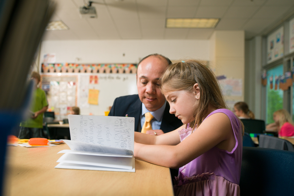 Jesus Santill�n, principal at Ada Vista Elementary helps a student with reading.