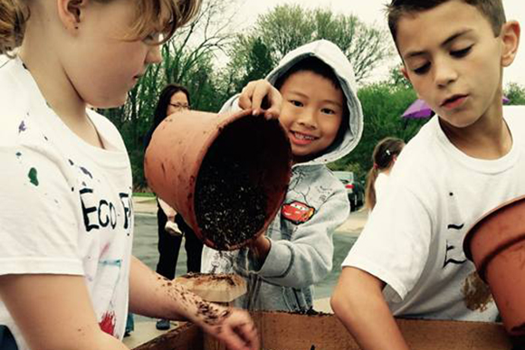 Angelina, Niko and Arthur contribute to their school's Michigan Green Schools designation by building a raised garden bed