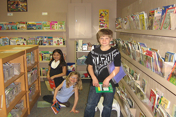 Students in the Just Right Library picking out books to take home and enjoy.
