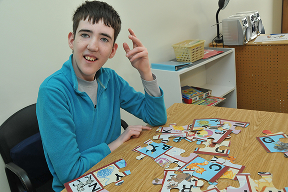 Student working on a puzzle in the classroom.