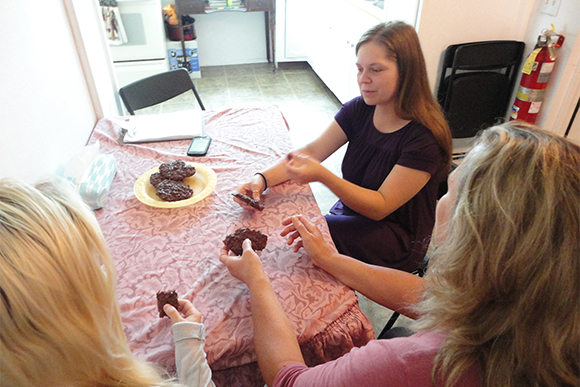 Jessie Taylor, center, shares a plate of homemade cookies with Laura McDowell, right, and Jessie�s sister, Megan Hearn.