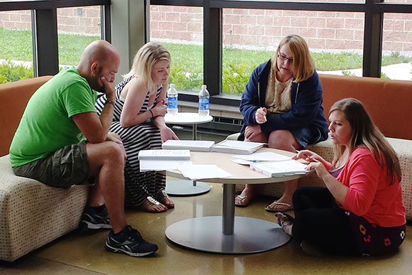 Teachers John Evans, Ashley Kerns, Pamela Krebs and Michelle Williams work to solve intense math problems during an Intel Math professional development.