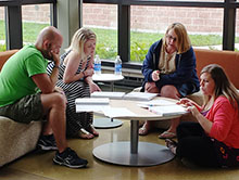 Teachers John Evans, Ashley Kerns, Pamela Krebs and Michelle Williams work to solve intense math problems during an Intel Math professional development.