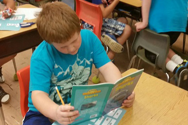 Student participating in high interest reading.