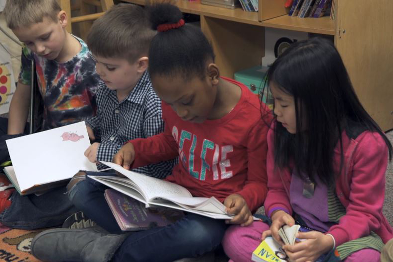 Students reading in the classroom.