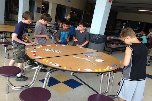 Students from Mrs. Szeliga's class use manipulatives to recreate a clock after completing a lesson in TenMarks, one of the web based math programs used this summer.