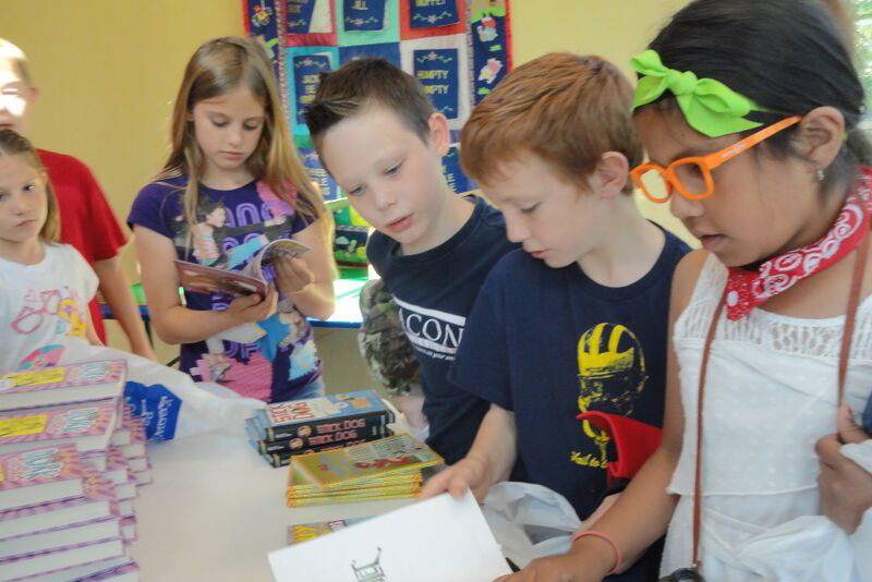 Students skim books on the last day of school.