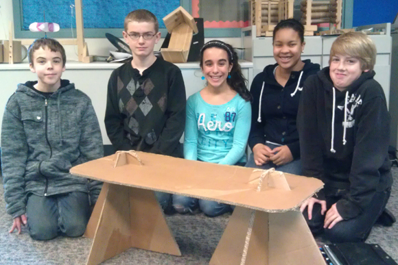 Clifford Smart Middle School students work to design homeless shelters made completely from pallets and other recycled materials.