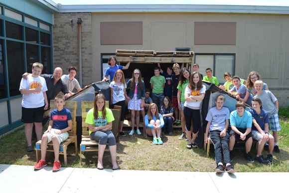 Kevin Olson, design tech teacher at Clifford Smart Middle School, poses with a group of his students.