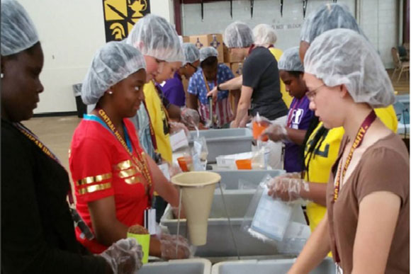 Young people join the fight against hunger by preparing meals for community members in need.