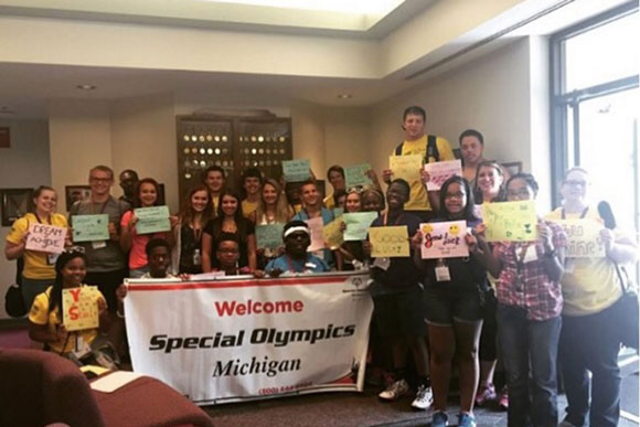 Students work with The LEAGUE Michigan to cheer on their peers competing in Special Olympics events.