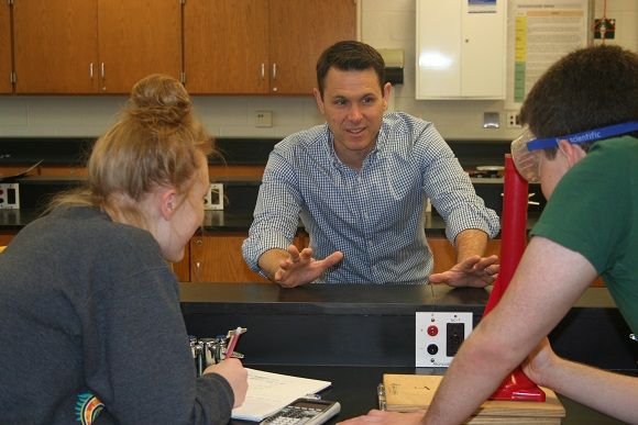 Physics teacher Brian Langley explains a lab experiment to students. 